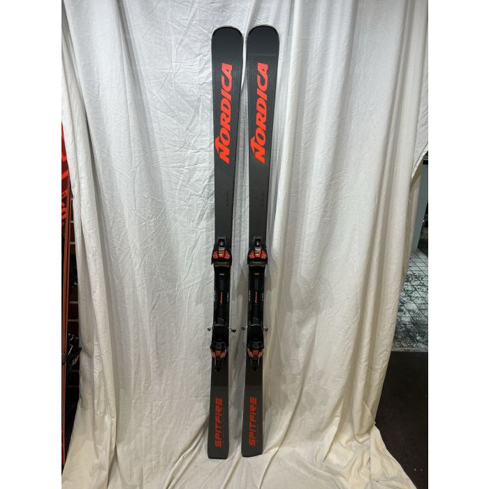 Nordica Spitfire DC 68 Pro FDT skis vooraanzicht – volledig paar zwart met rode grafische elementen en Xcell 12 FDT bindingen, staand tegen witte achtergrond